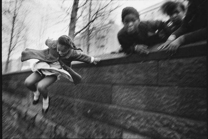 Girl Jumping over a Wall