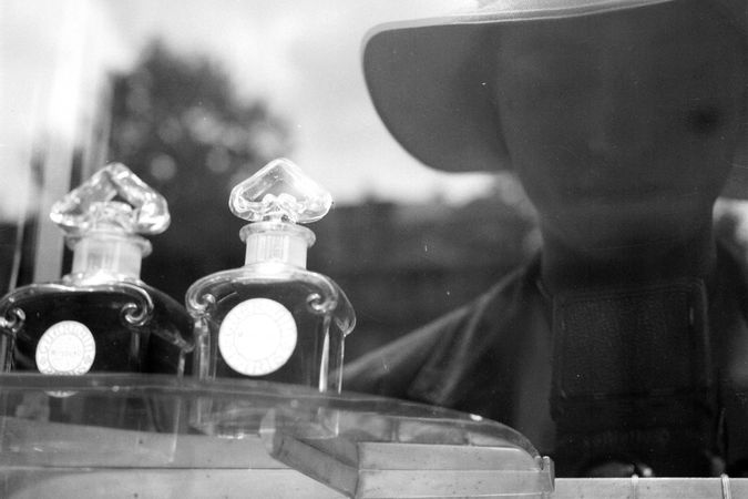 Reflection of Lee Miller in the Guerlain shopfront window