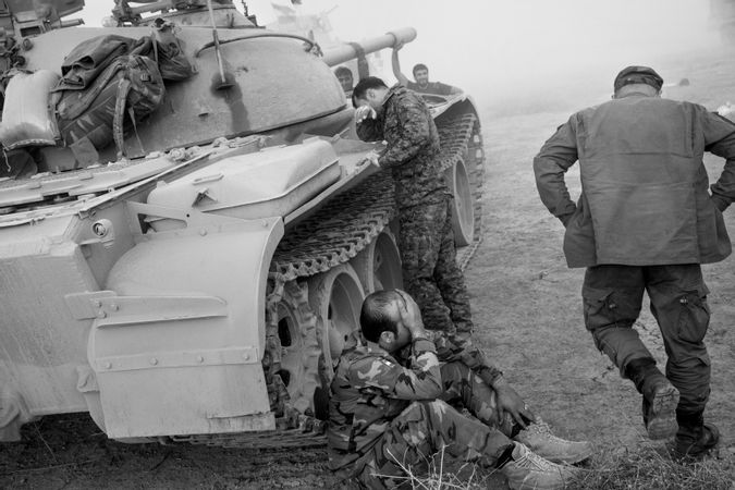 Kurdisn peshmerga mourn the death of one of their comrades