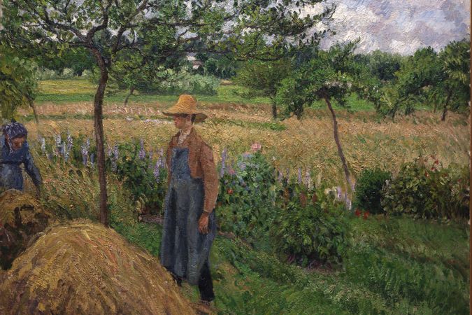 Gardener standing by a Haystack, overcast sky