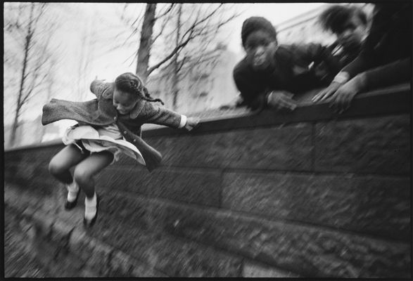 Girl Jumping over a Wall