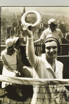 Rooftop deck-tennis players, against Manhattan skyline