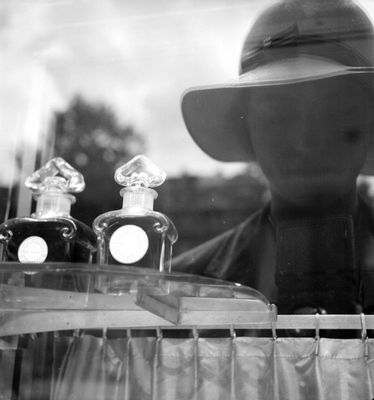 Reflection of Lee Miller in the Guerlain shopfront window