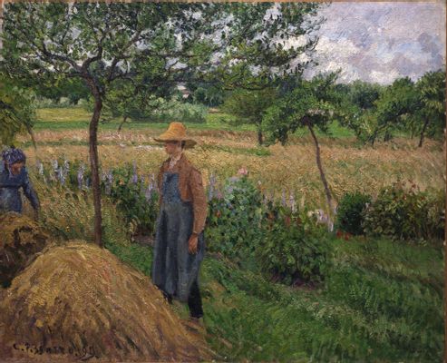 Gardener standing by a Haystack, overcast sky